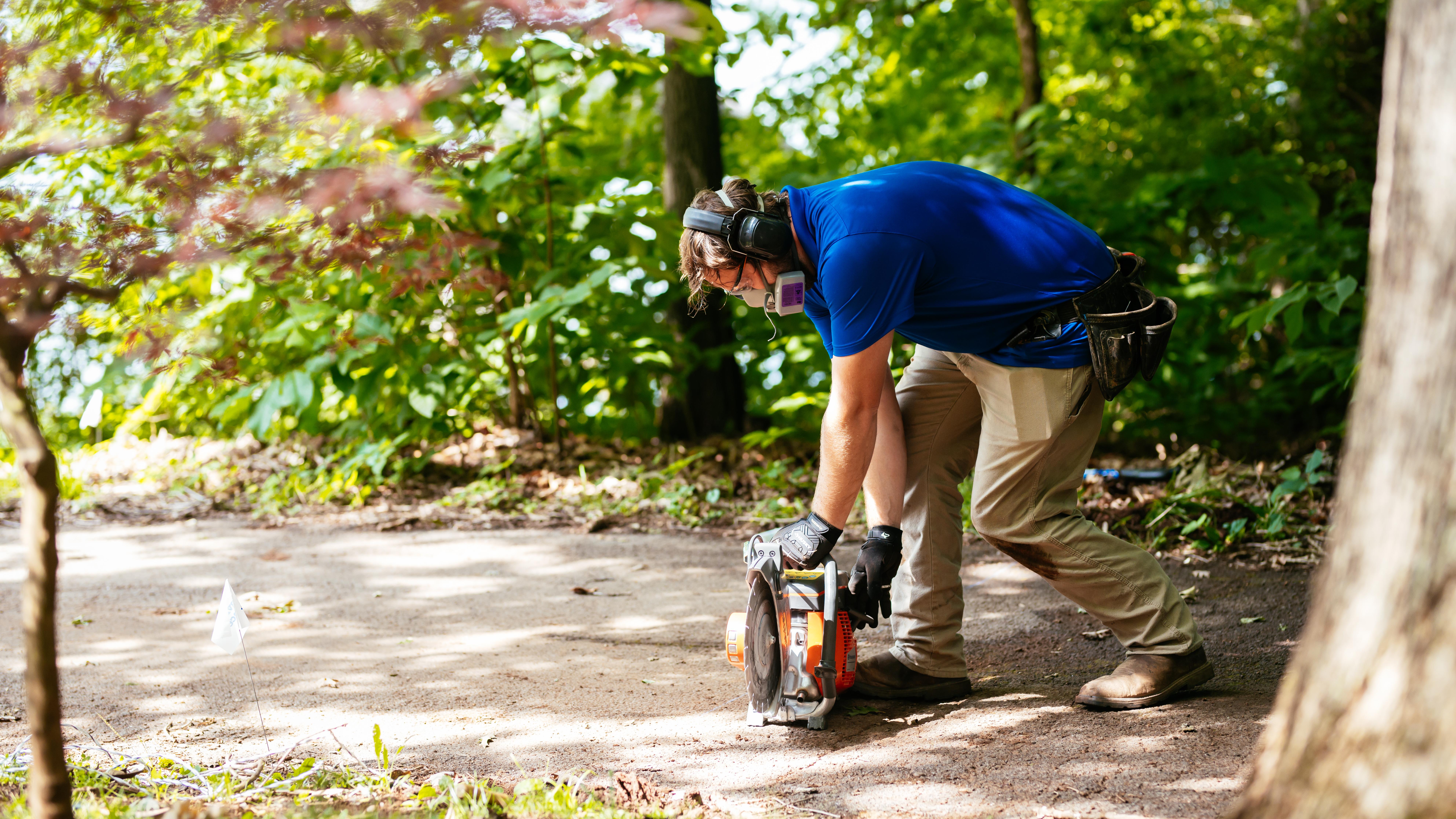 Invisible Fence technician installing a system across a driveway