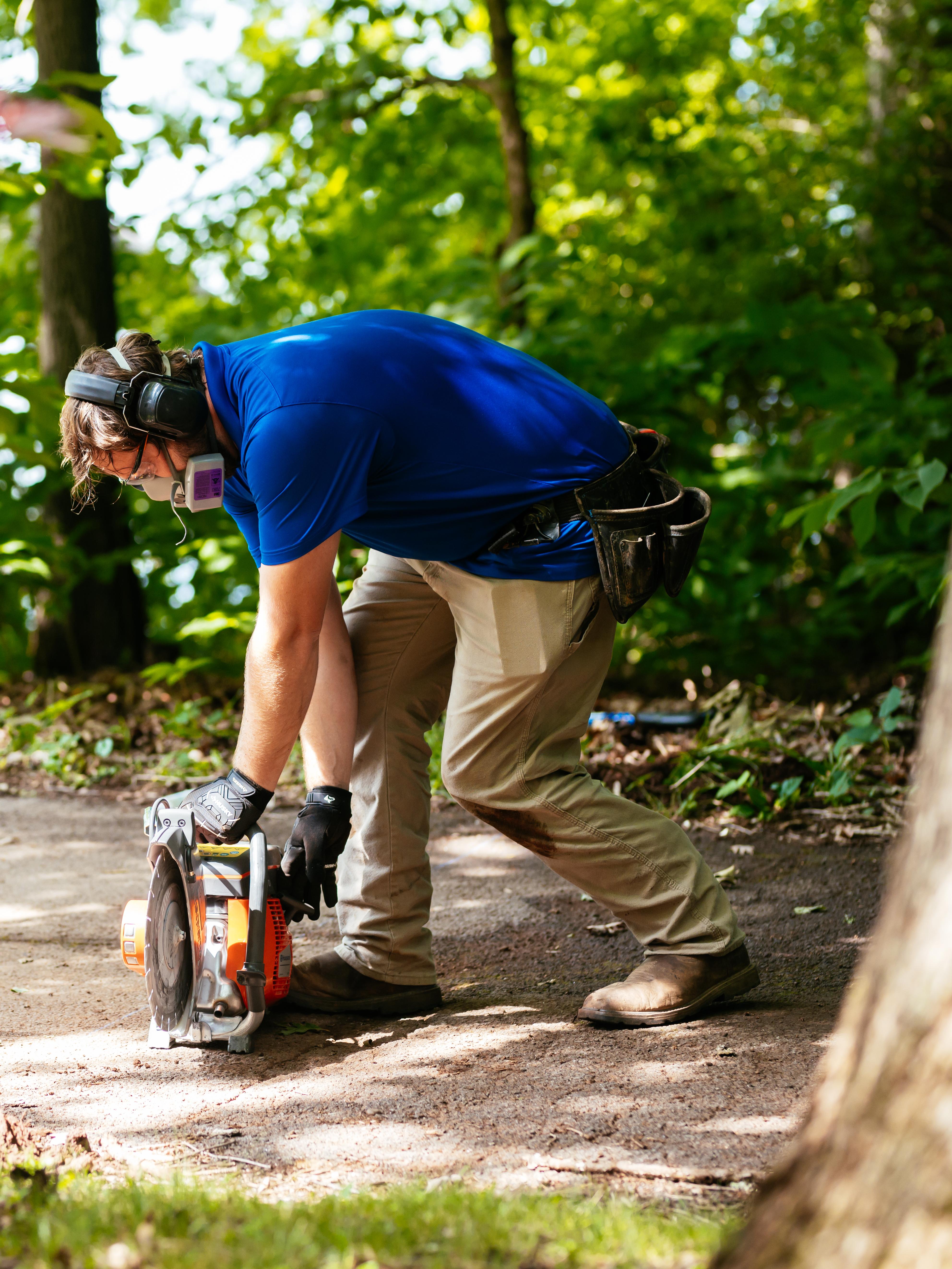 Invisible Fence technician installing a system across a driveway