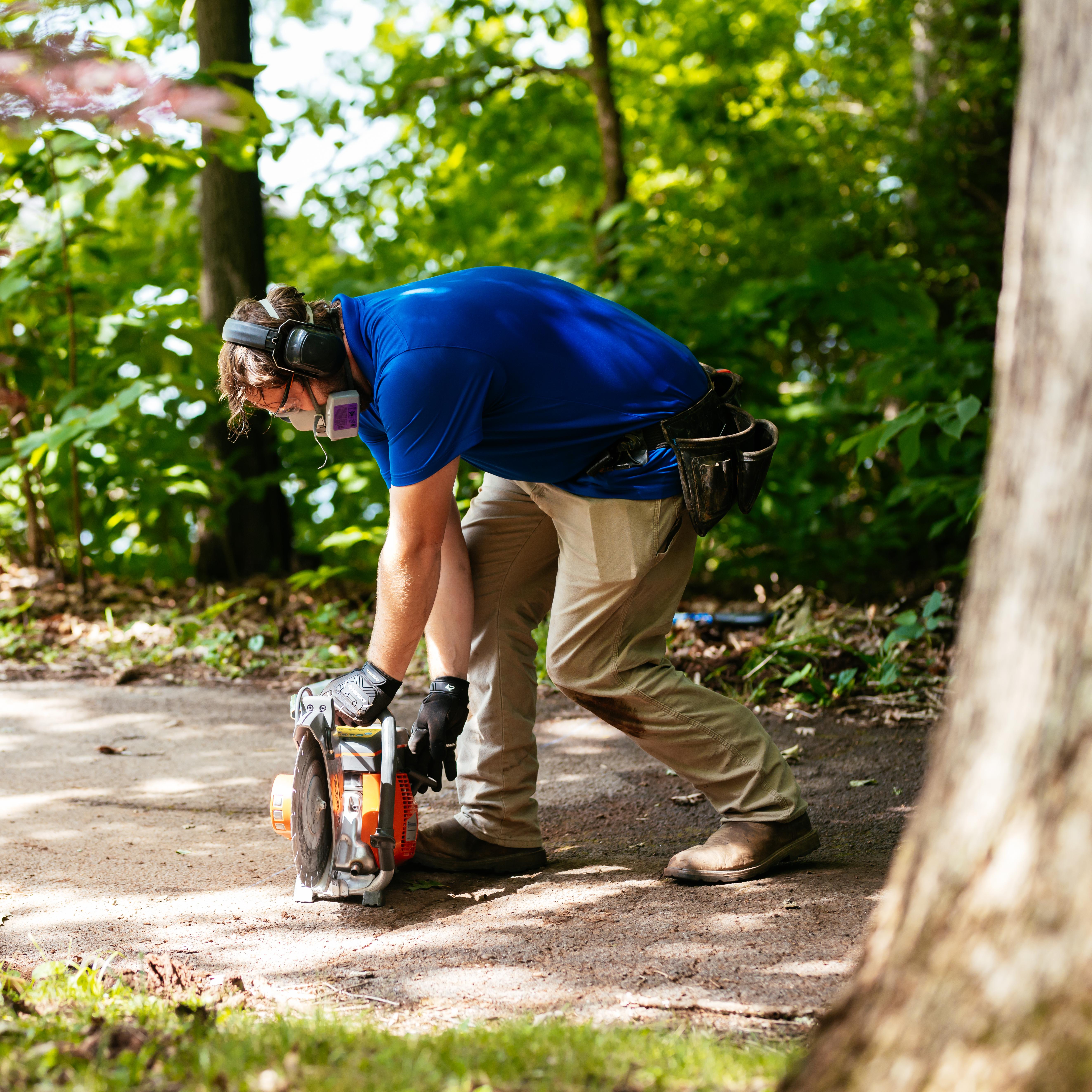 Invisible Fence technician installing a system across a driveway