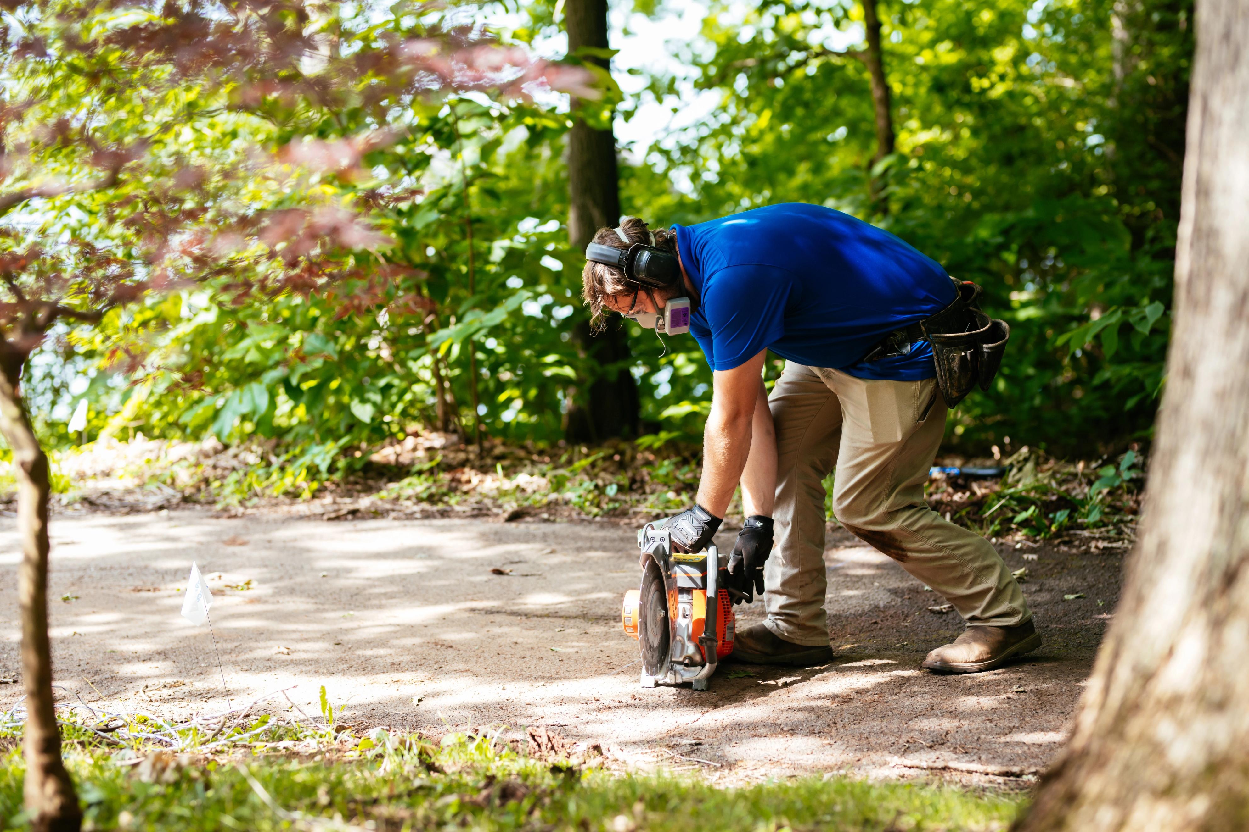 Invisible Fence technician installing a system across a driveway