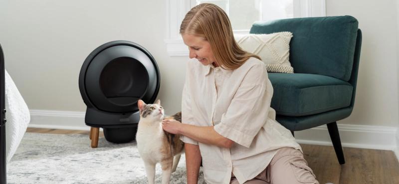Woman petting cat with chair and SmartSpin in background