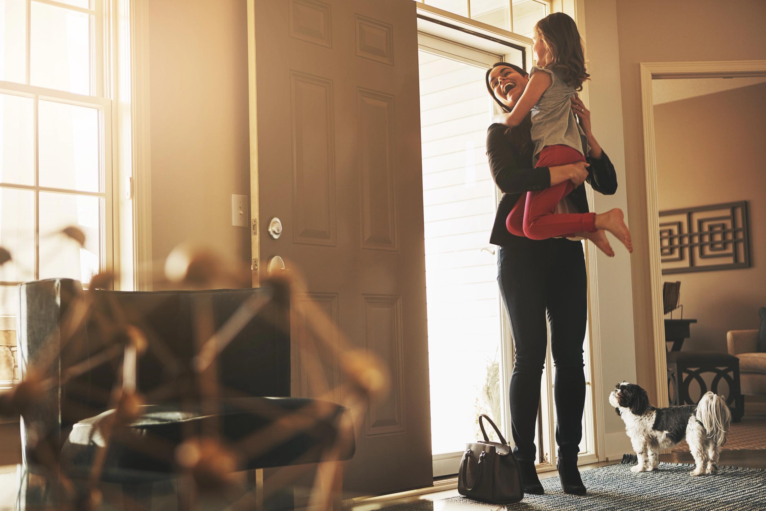 dog sitting calmly by front door as owner opens with invisible fence shields installed