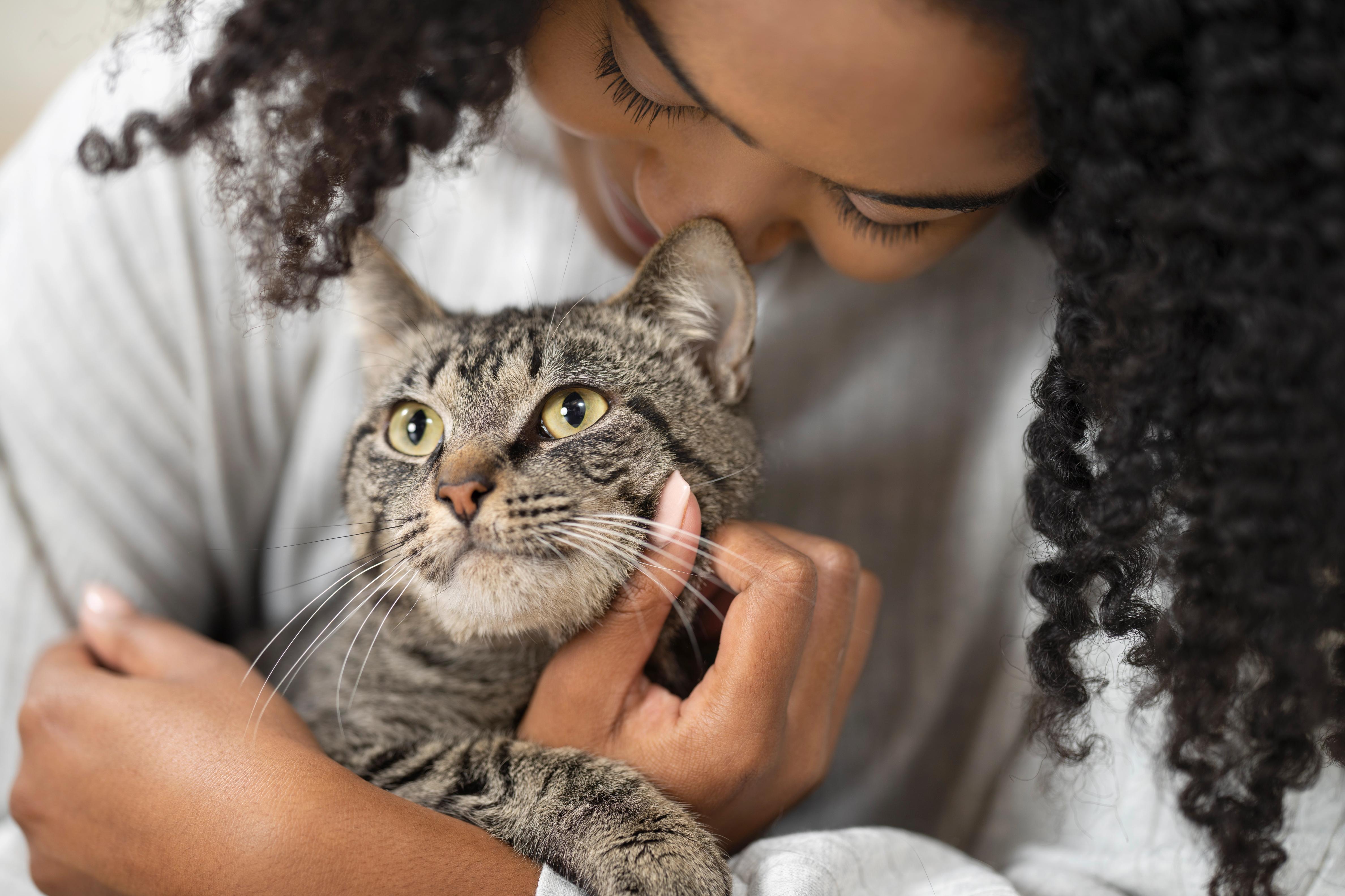 Woman snuggling cat