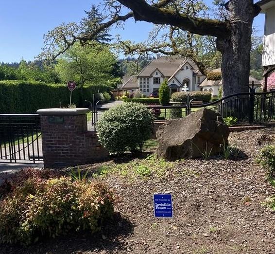 Pet protected by invisible fence sign in front of Seattle home