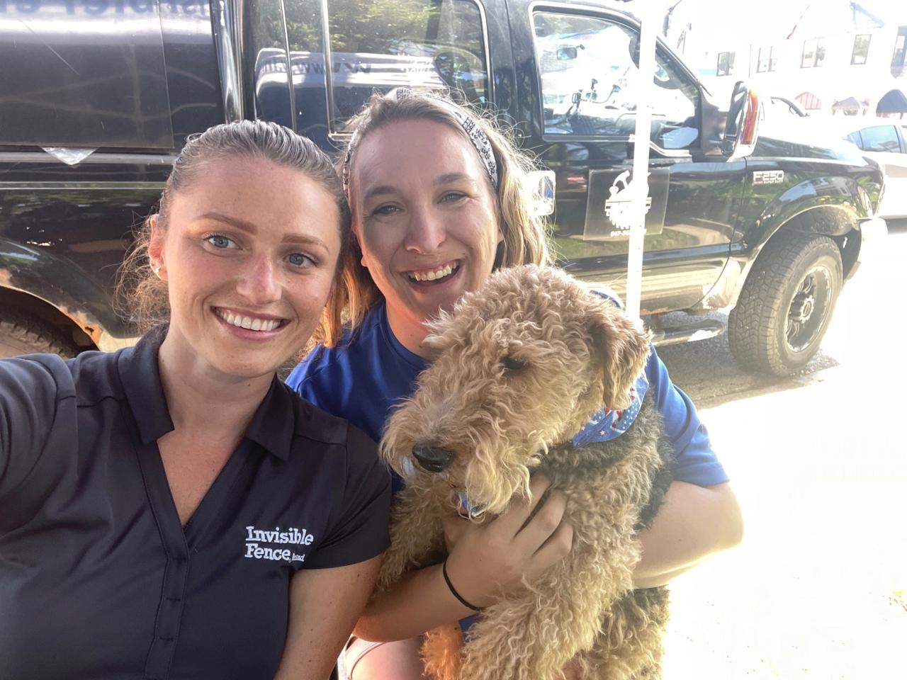  Invisible Fence of Chicago trainers working with a dog at a local event