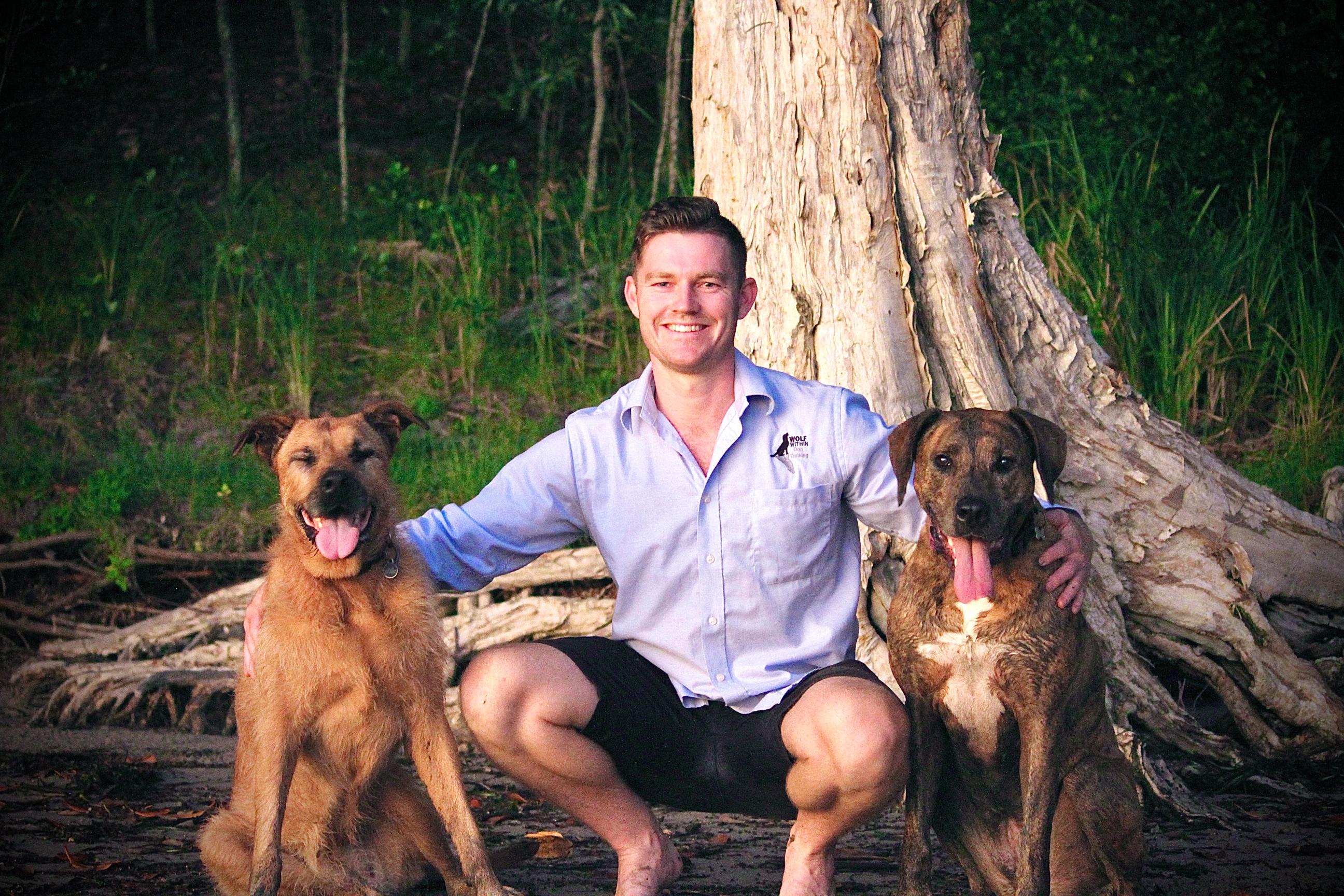 man with two dogs