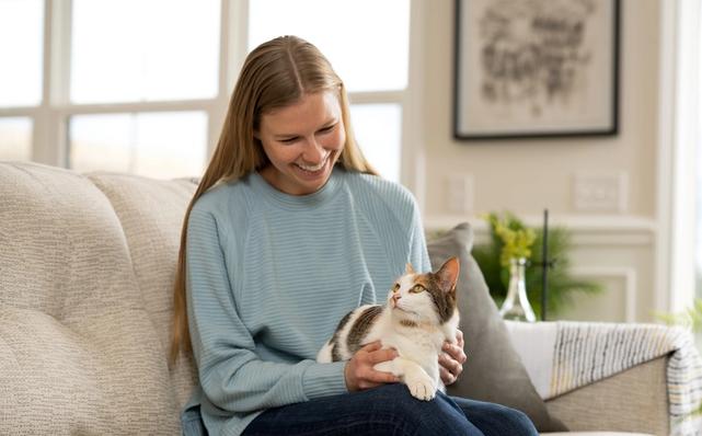 Woman sitting with cat on her lap