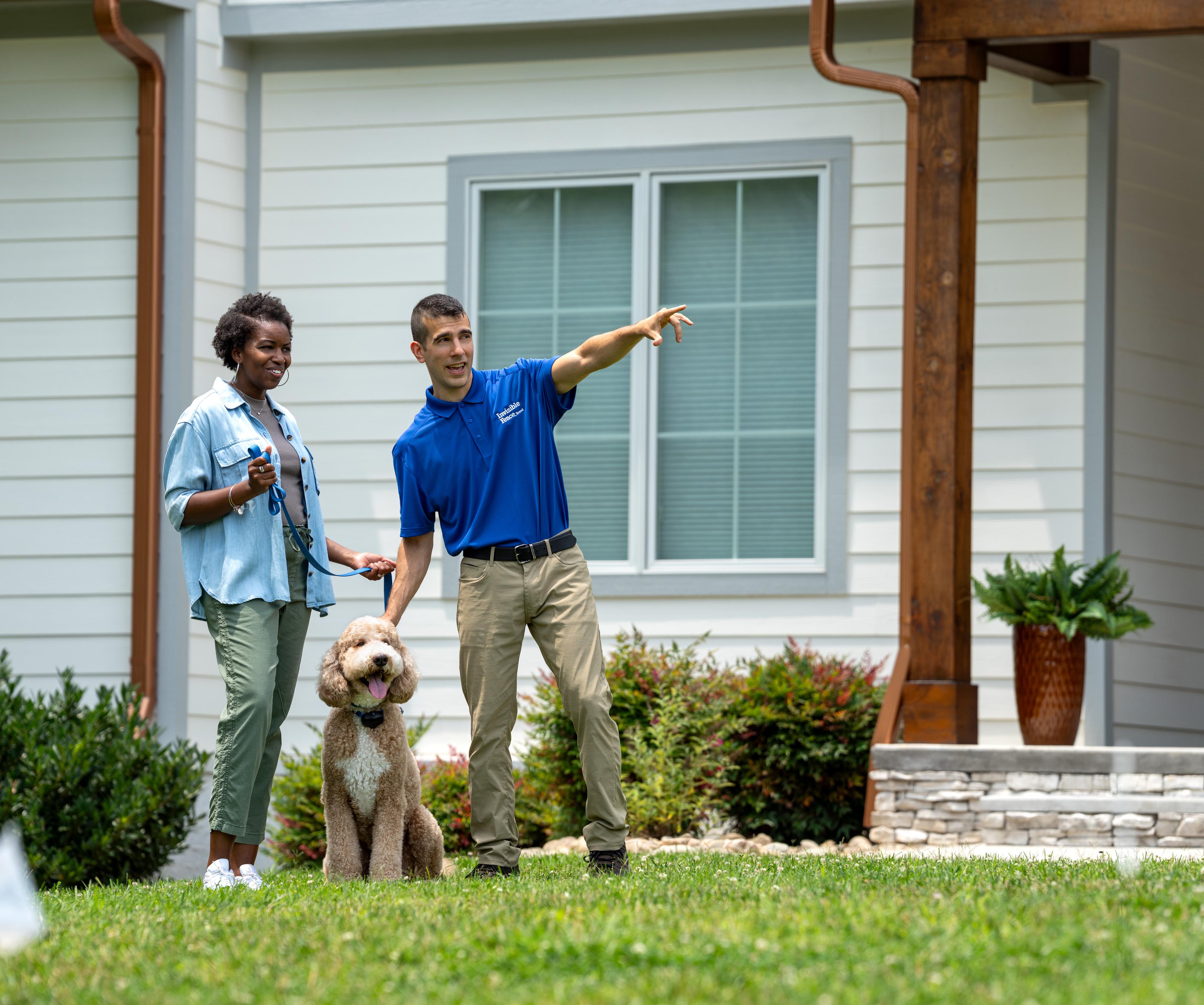 certified invisible fence brand trainer with dog and owner during professional training session