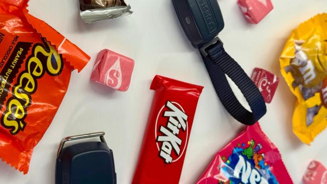 Halloween candy scattered with GPS dog and cat trackers