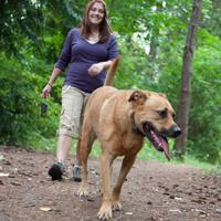 woman and dog walking at park