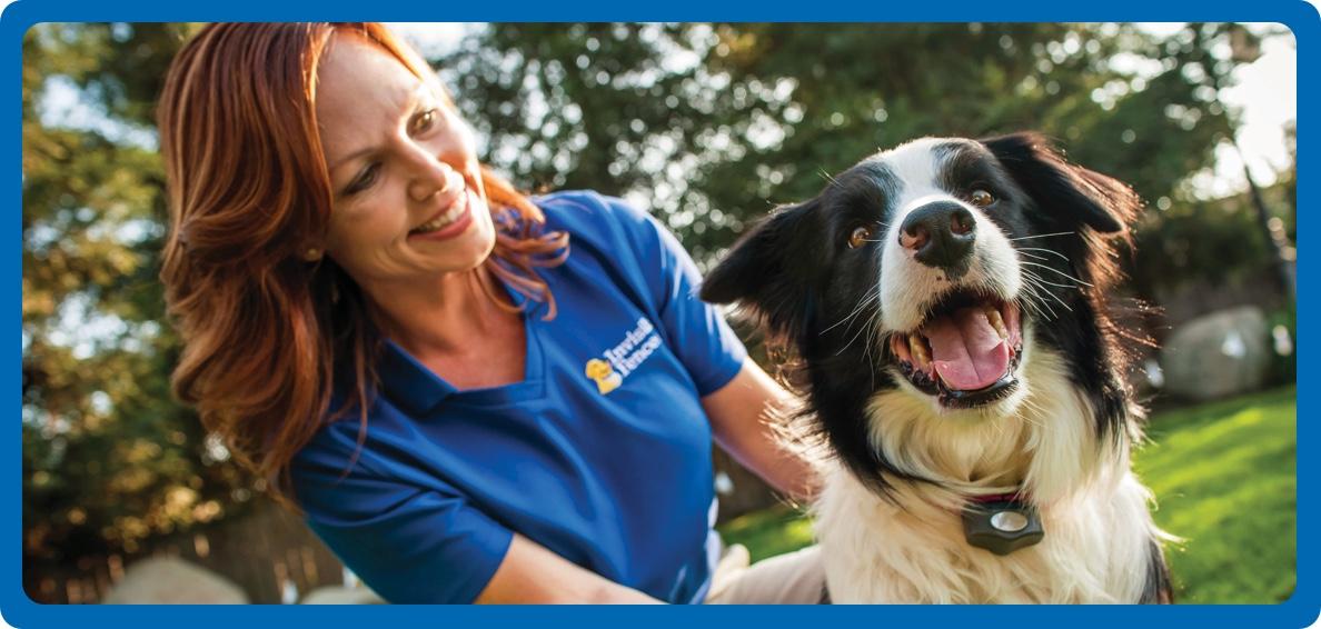IFB technician smiling with arms wrapped around happy dog