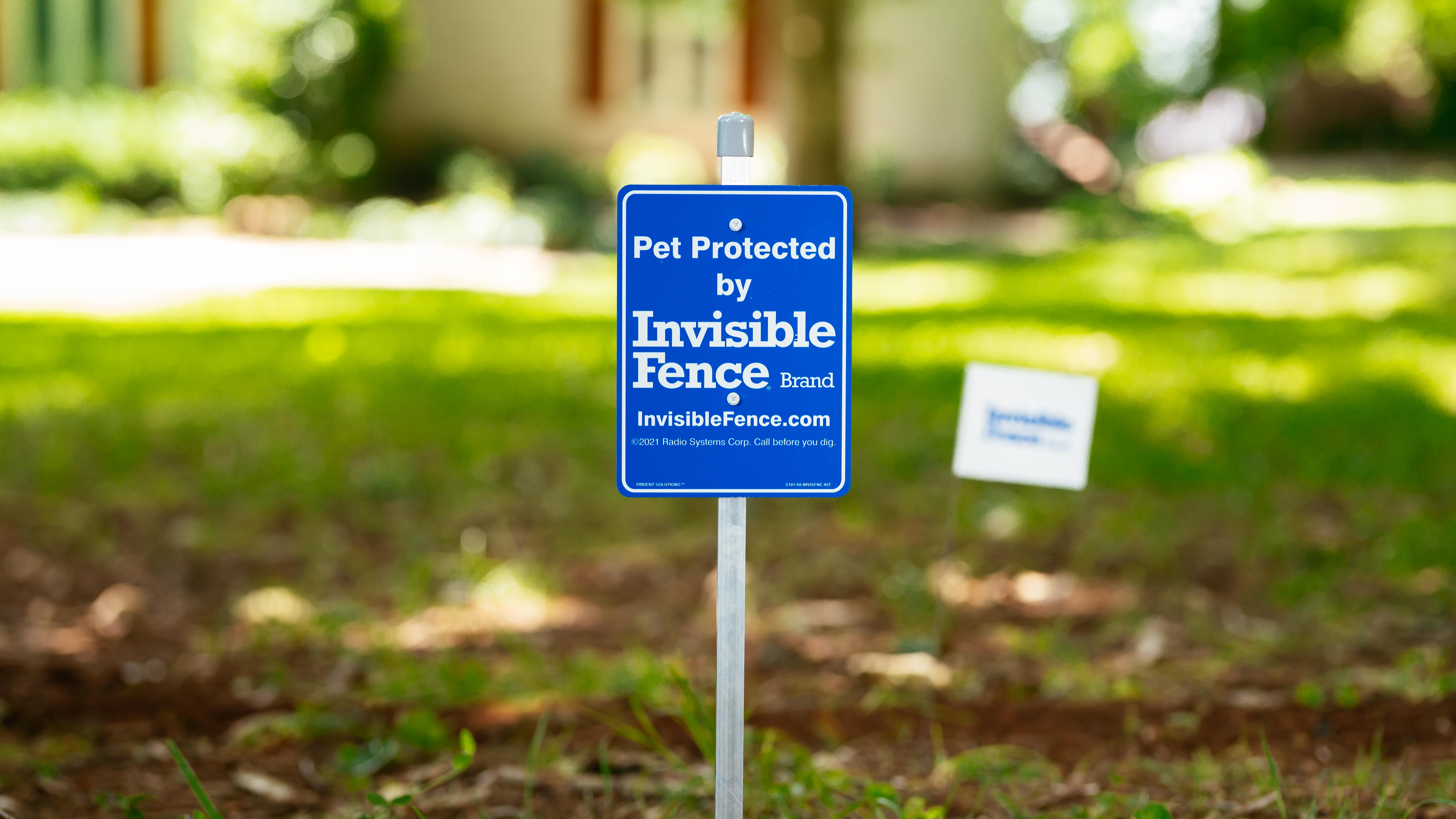 Pet Protected by Invisible Fence Brand sign in front yard.