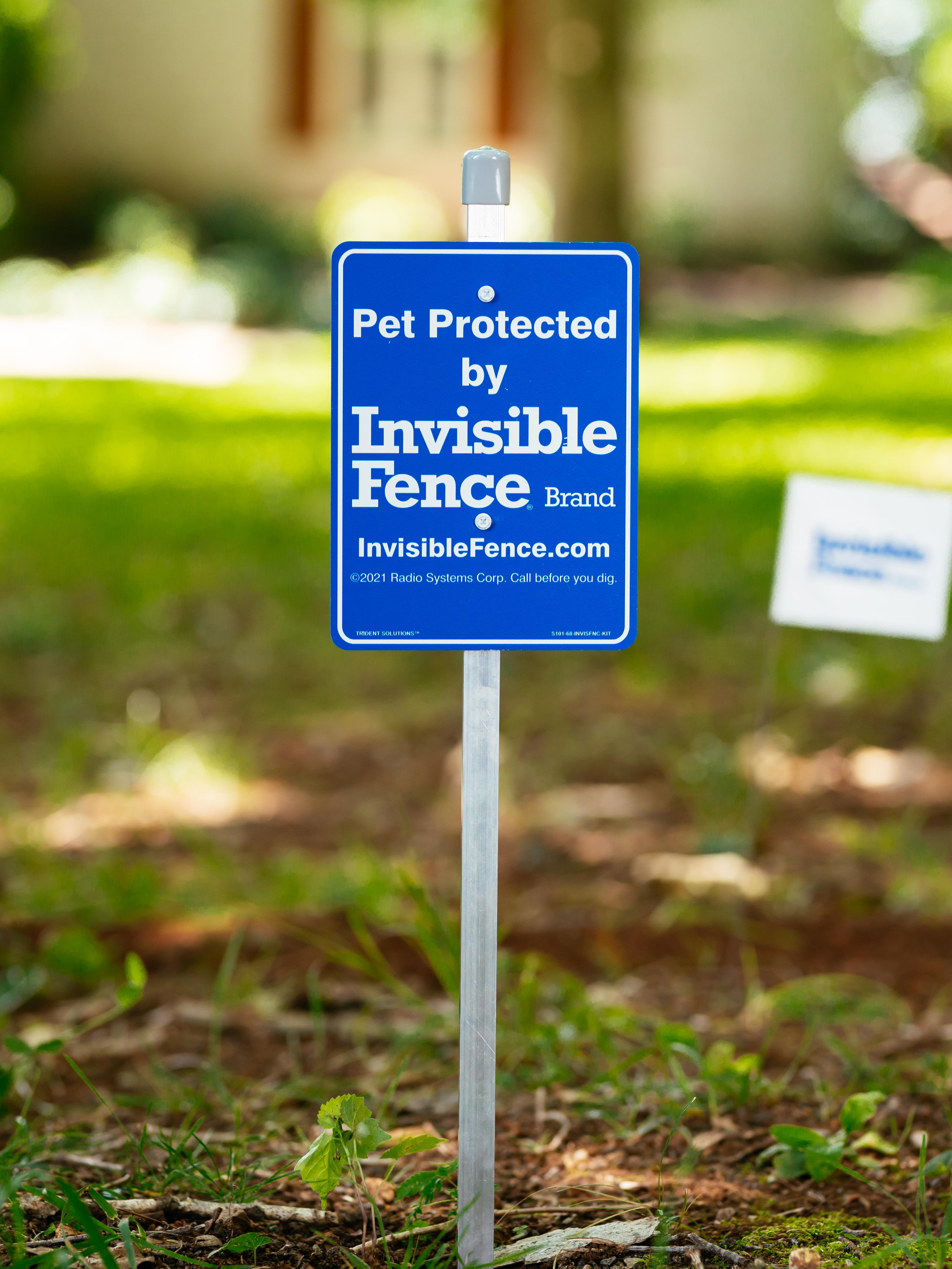 Pet Protected by Invisible Fence Brand sign in front yard.