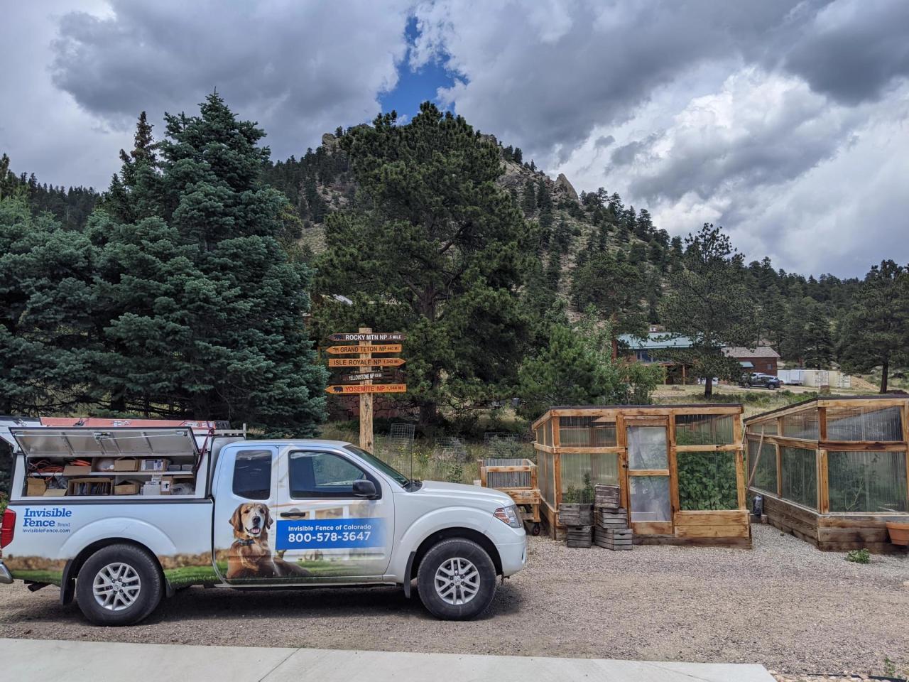 invisible fence truck parked in local colorado yard with mountains in the background