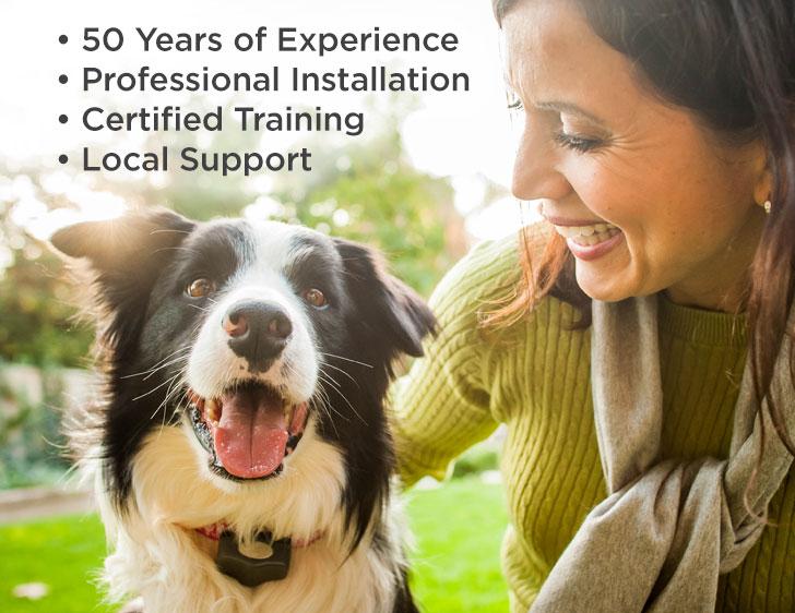 Nicely dressed woman petting a happy Border Collie dog wearing an Invisible Fence® brand collar. The image highlights 50 years of experience, professional installation, certified training, and local support.