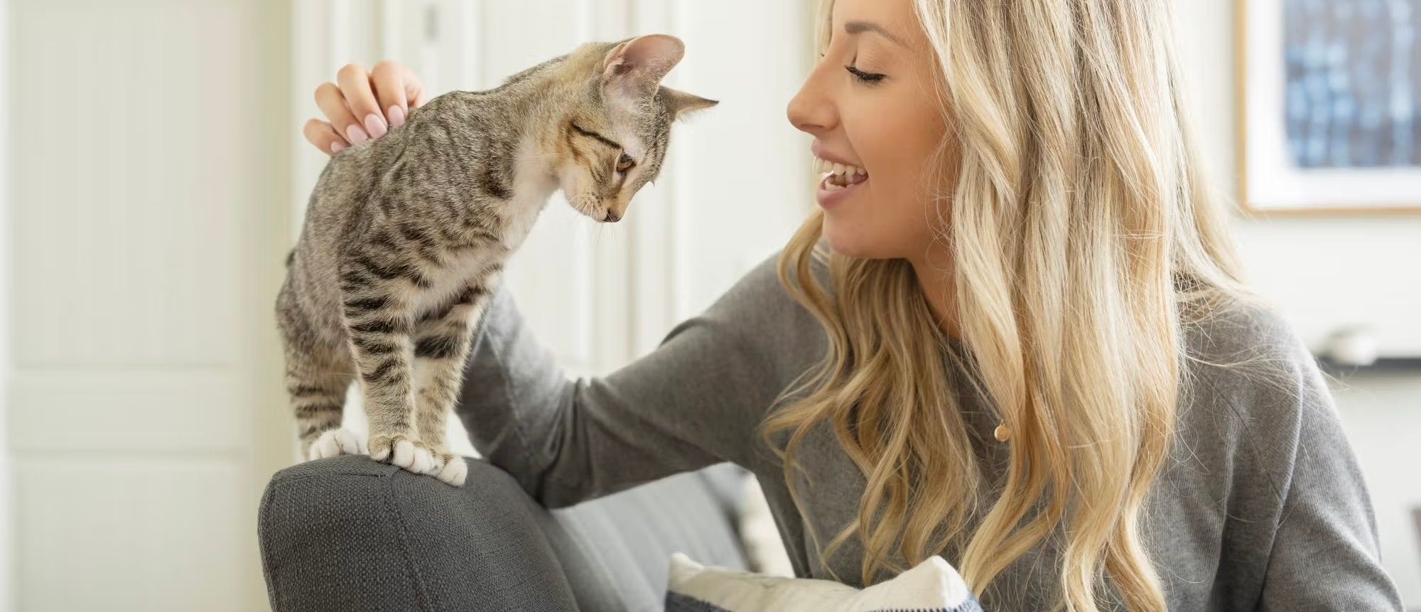 Woman holding her cat affectionately