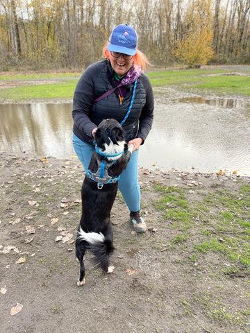 Jenny (she/her) dancing with Big Judy at the dog park.