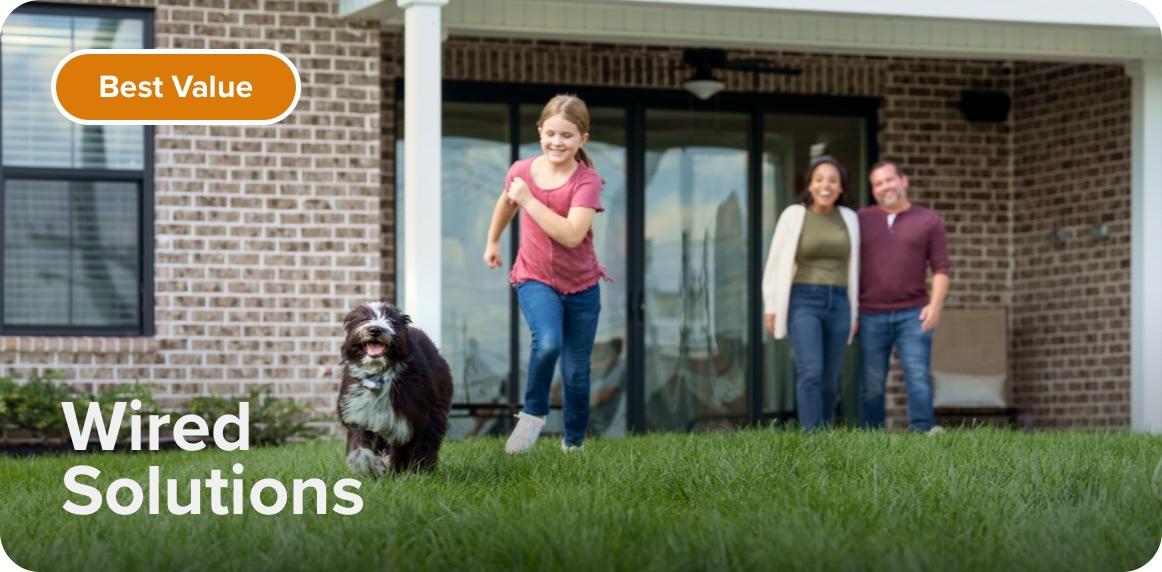 Best Value. Wired Solutions. Image of a family enjoying a sunny day outside while their dog runs playfully in the green grass.