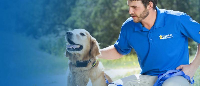 Invisible Fence trainer petting dog outside.