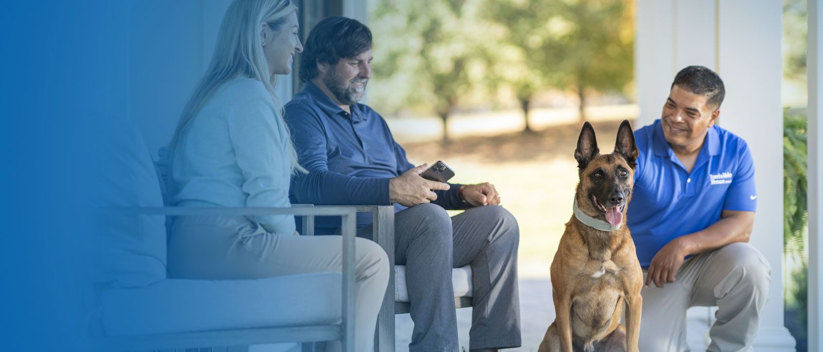 A professional trainer works with a couple to familiarize everyone with the Invisible Fence® and collar.