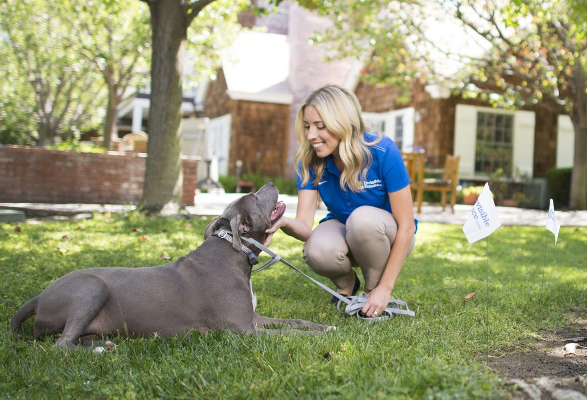 Invisible Fence trainer working with dog outdoors