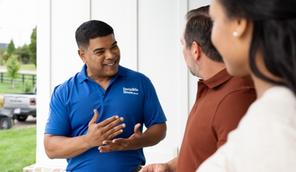 A certified Invisible Fence professional meeting with a couple