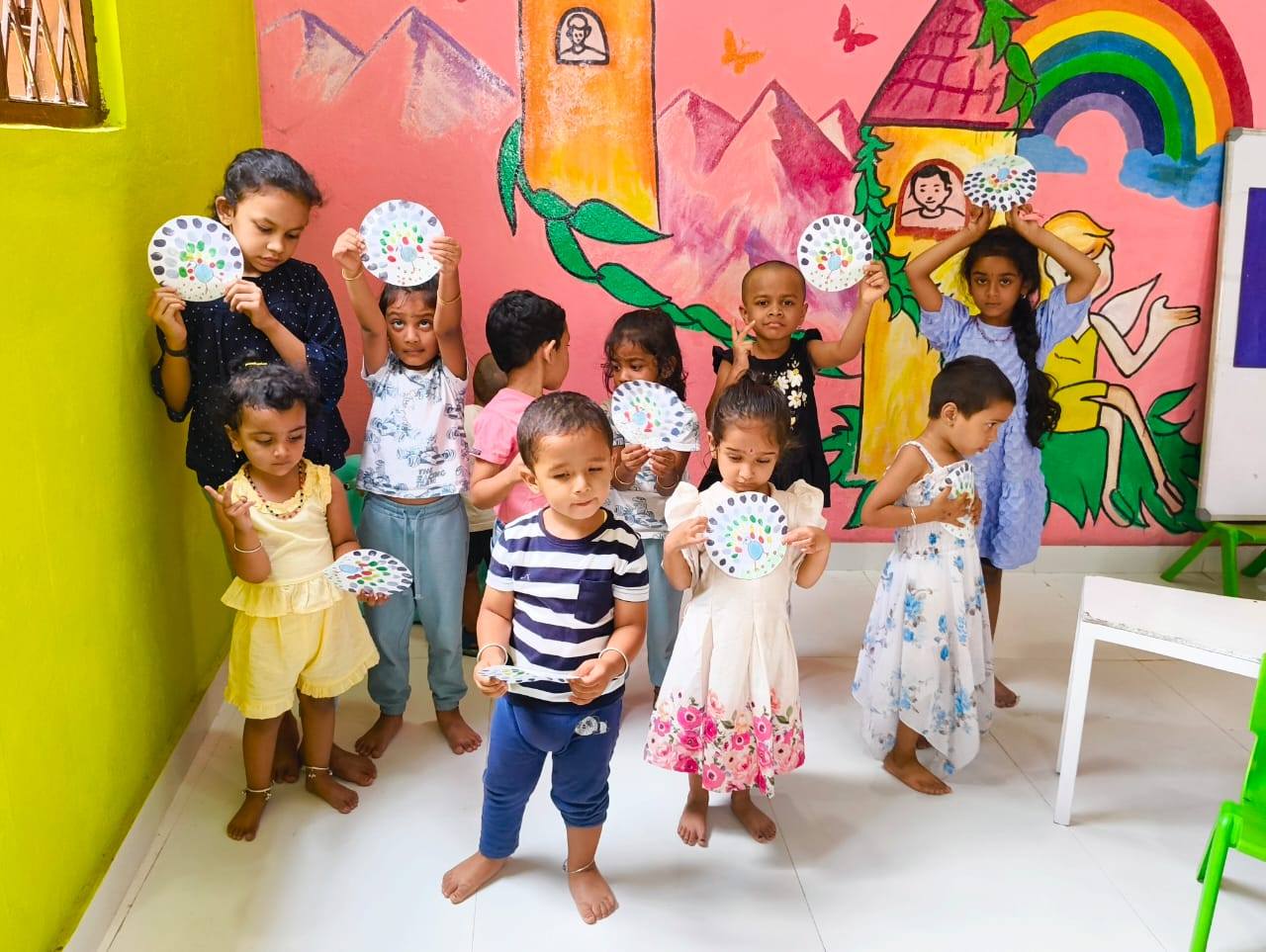 Children showing artwork at T.I.M.E Kids preschool classroom Horamavu