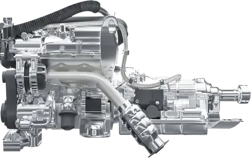 Highly detailed and polished metal automotive component, an engine part. The machinery is complex, with numerous interconnected parts, including gears, pipes, and housings. The metal surface is shiny, reflecting light and highlighting the intricate design of the component. Hoses and cables are attached to the unit.