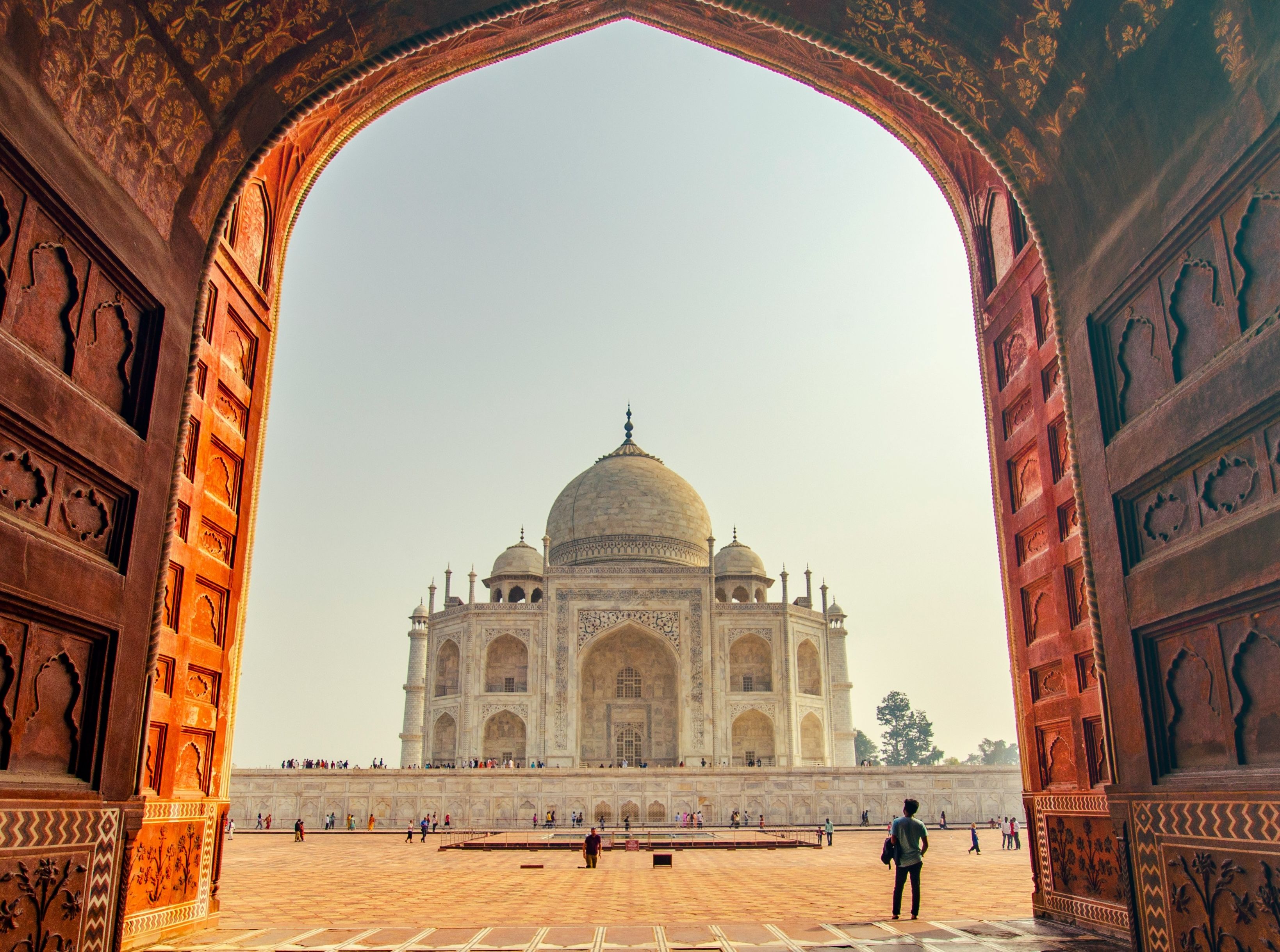 view of the Taj Mahal in India under an arch