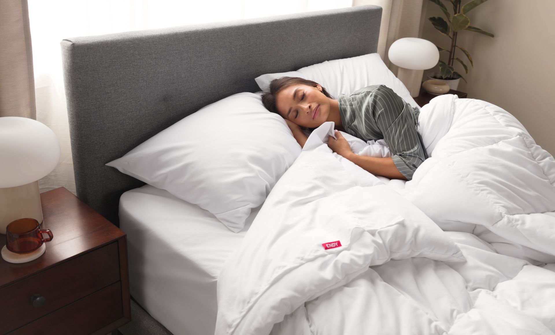 Person sleeping on an Endy Mattress outfitted with The Endy Everyday Sleep Set.