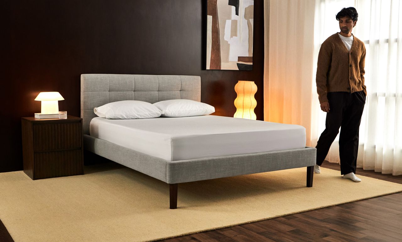 Bedroom showcasing the tufted upholstered bed frame in ash grey colourway.