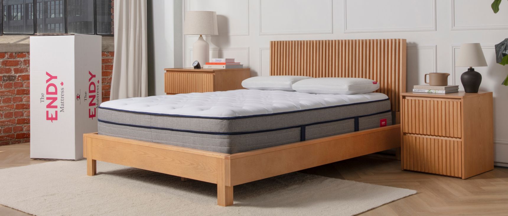 Bare Endy Hybrid mattress on a wooden bedframe in a minimalistic bedroom