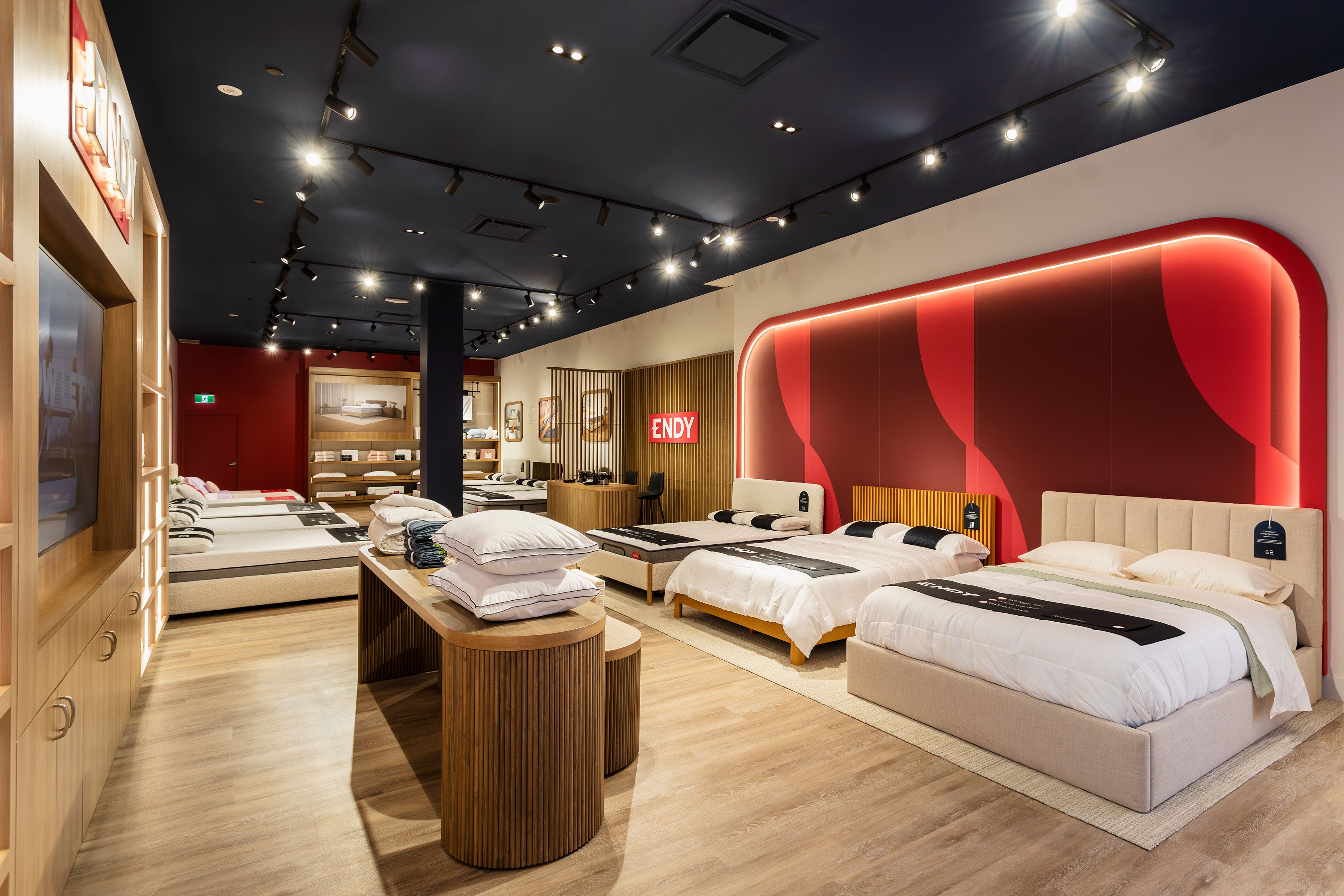 Interior of Endy Bayshore store, with mattresses lined up along the wall under an Endy sign