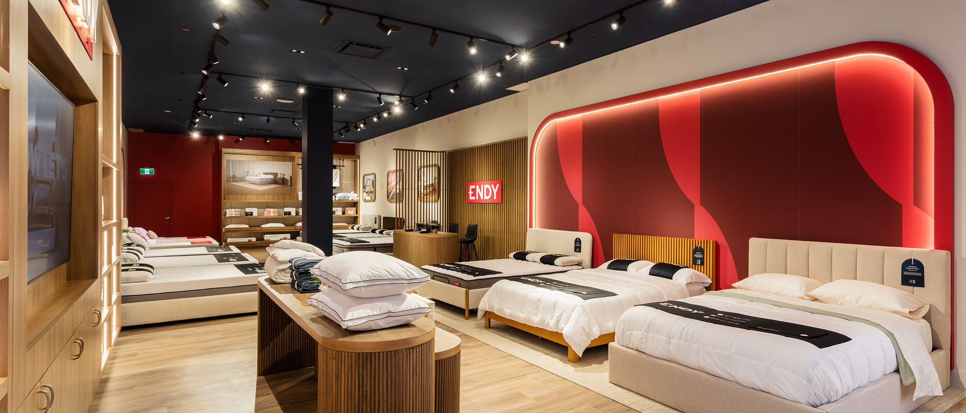 Interior of Endy Bayshore store, with mattresses lined up along the wall under an Endy sign