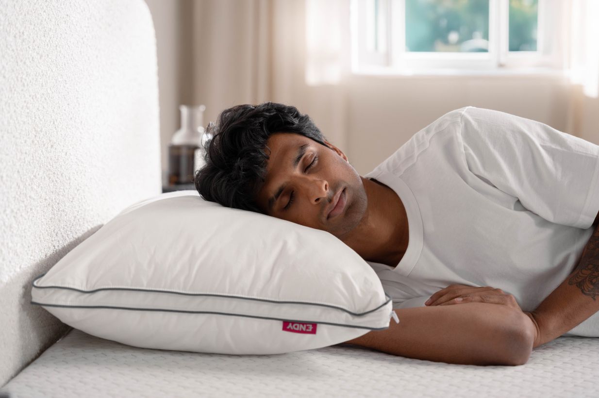 Man sleeping on a side on an Endy Customizable Pillow