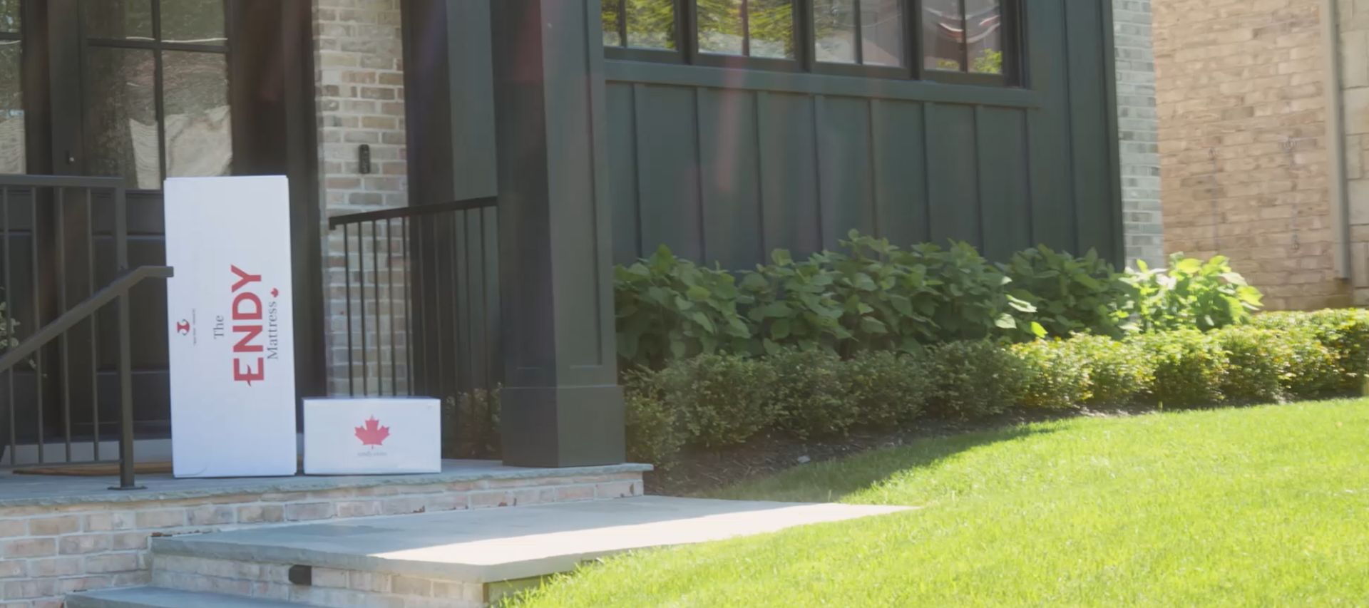 An Endy Mattress box sitting on someone's front porch