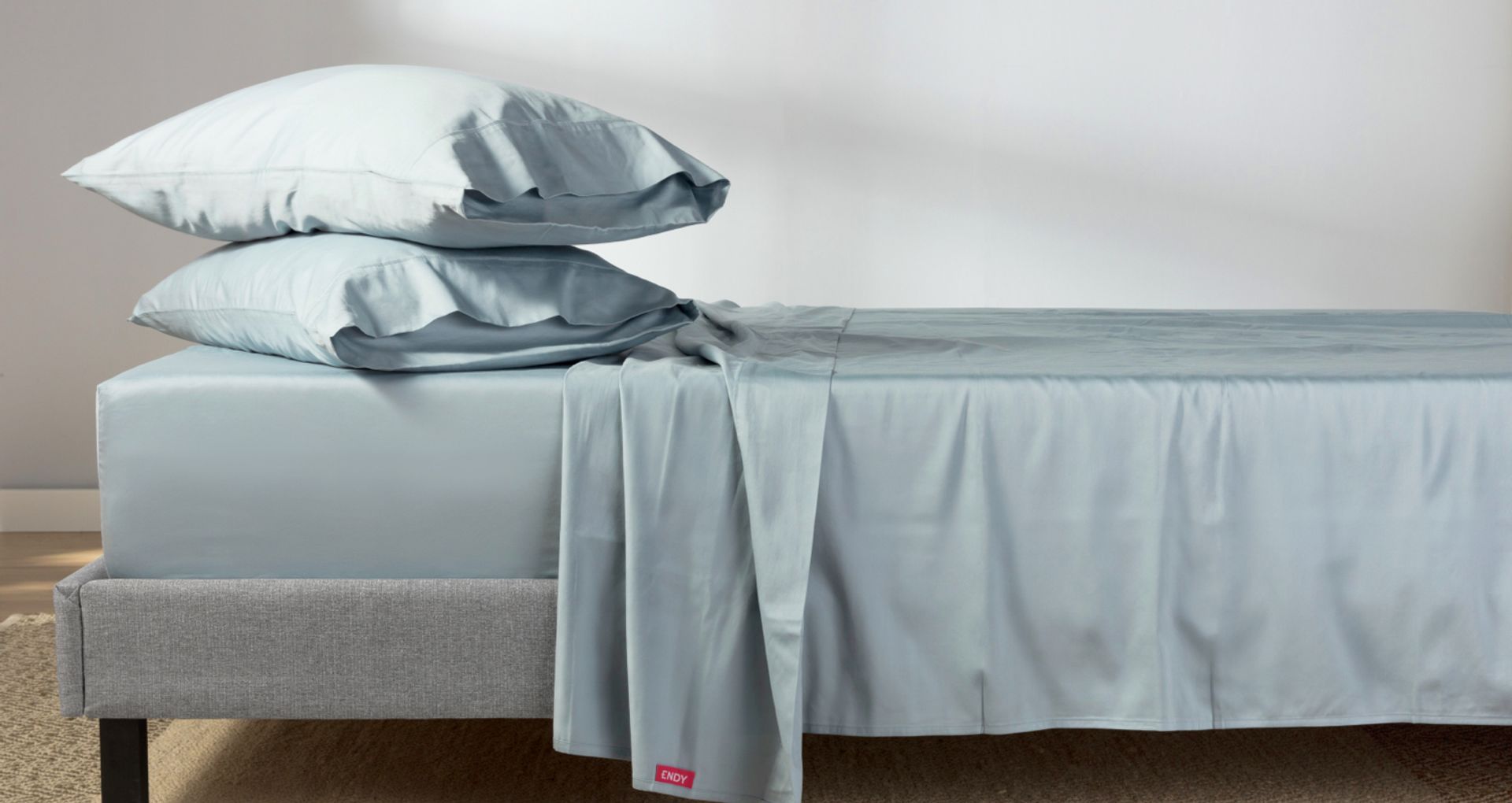 A bed dressed in Endy's collection of sleep products.