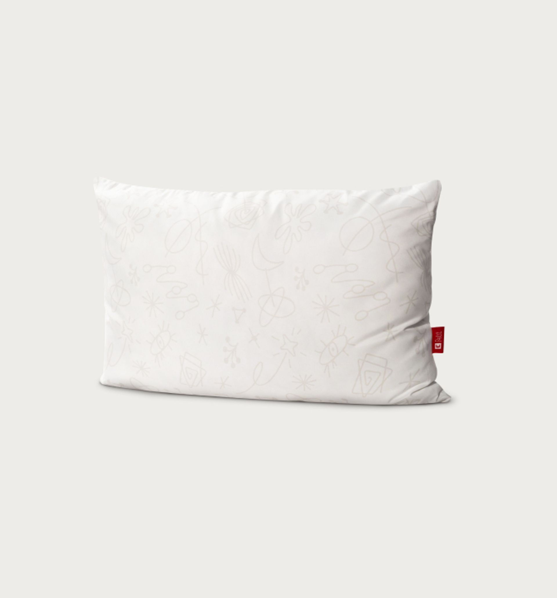 Endy Petit kids pillow against a beige background