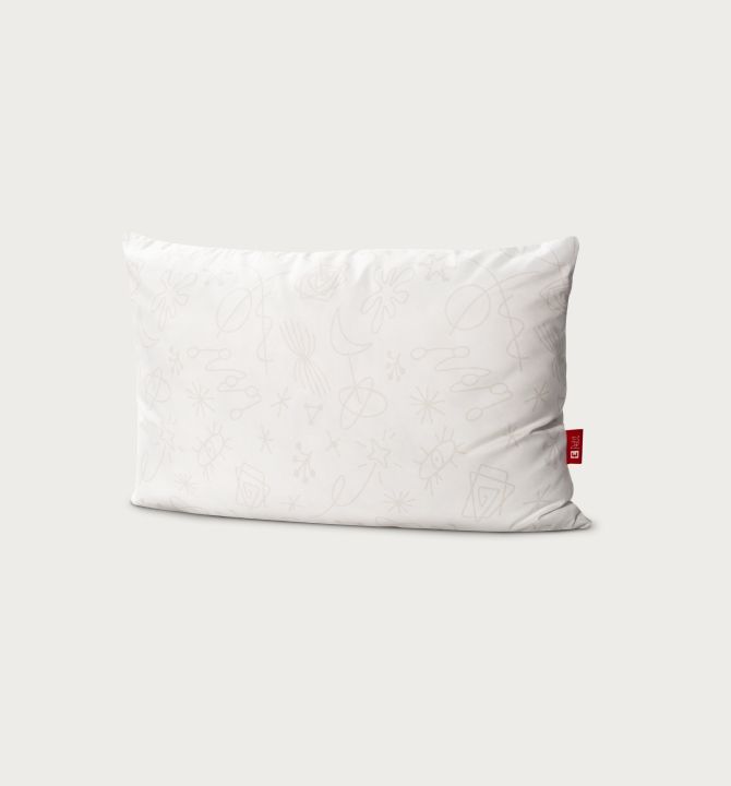 Endy Petit kids pillow against a beige background
