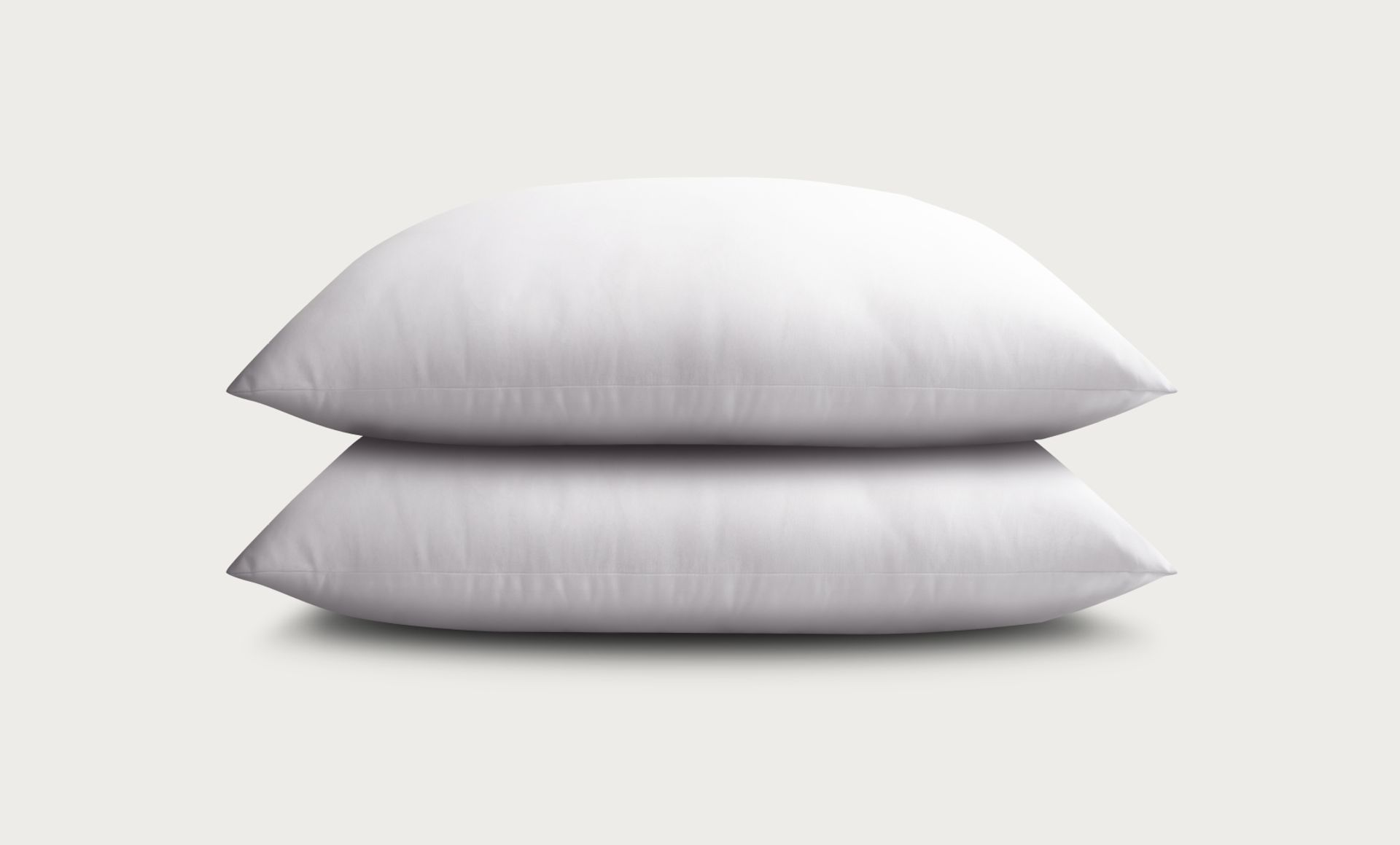 2 Endy Everyday Pillows stacked on top of each other, against a grey background