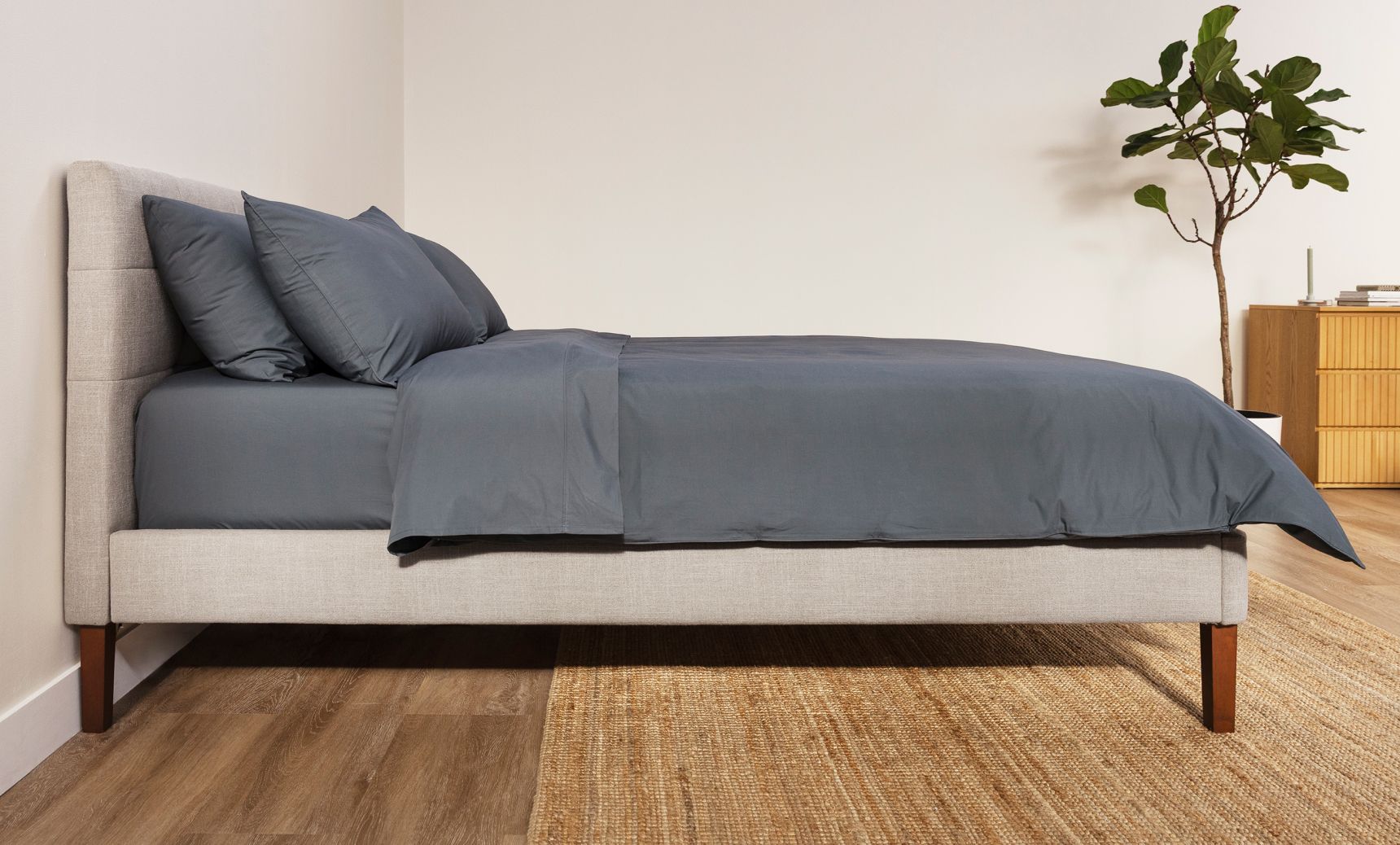 Tufted Upholstered Bed Frame in ash grey made with midnight navy bedding.