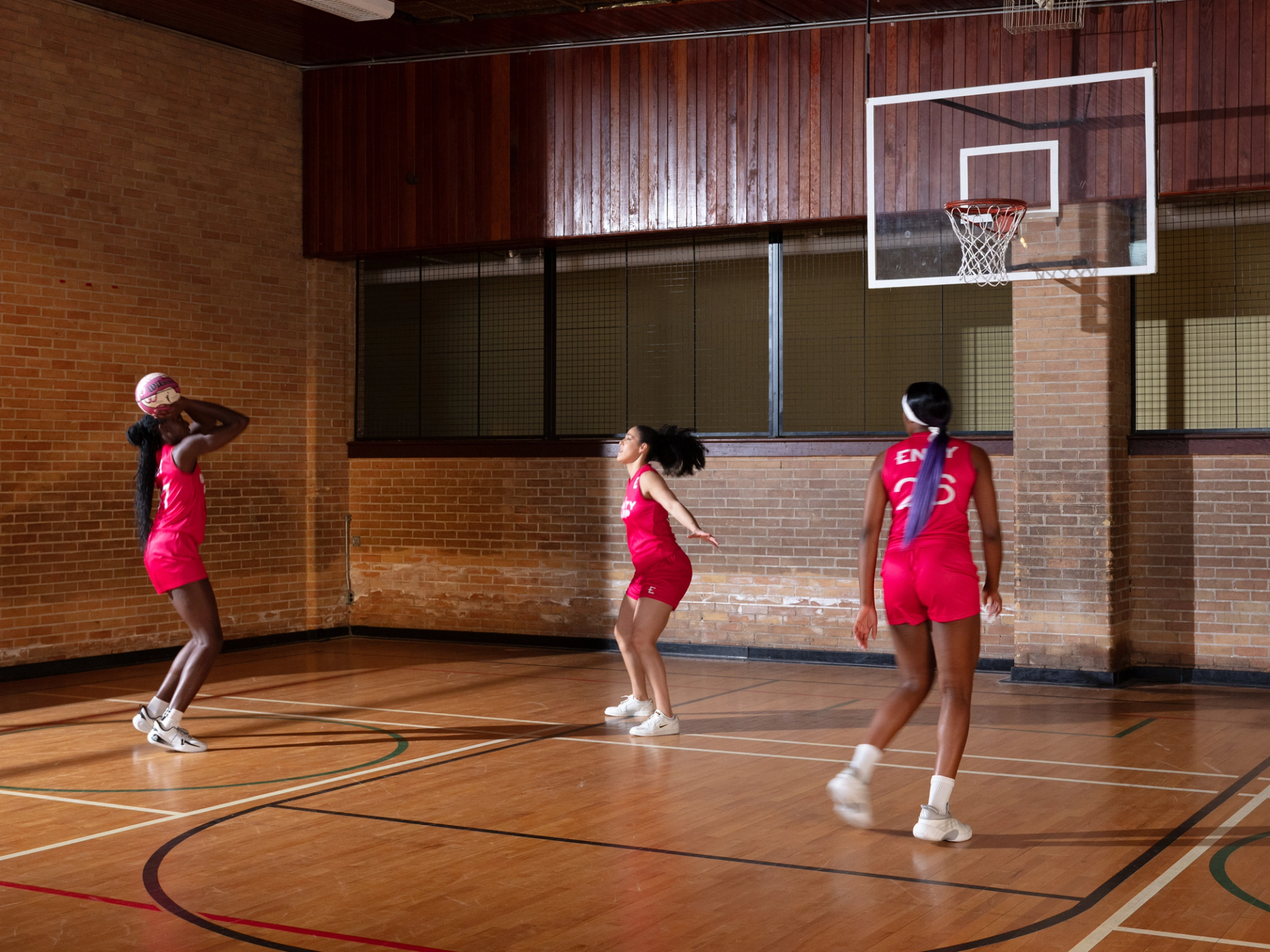 Laeticia Amihere, Kia Nurse, and Aaliyah Edwards playing basketball in Endy jerseys