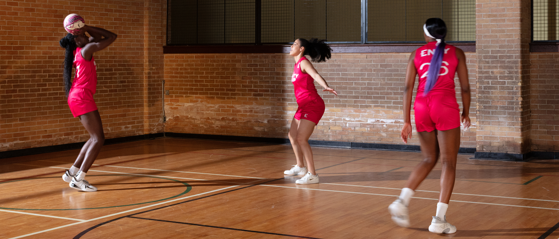 Laeticia Amihere, Kia Nurse, and Aaliyah Edwards playing basketball