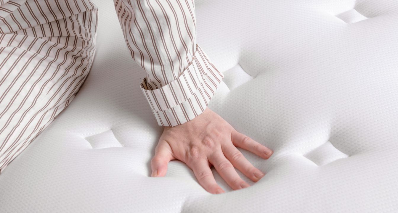 Hand pressing on Endy Hybrid Mattress