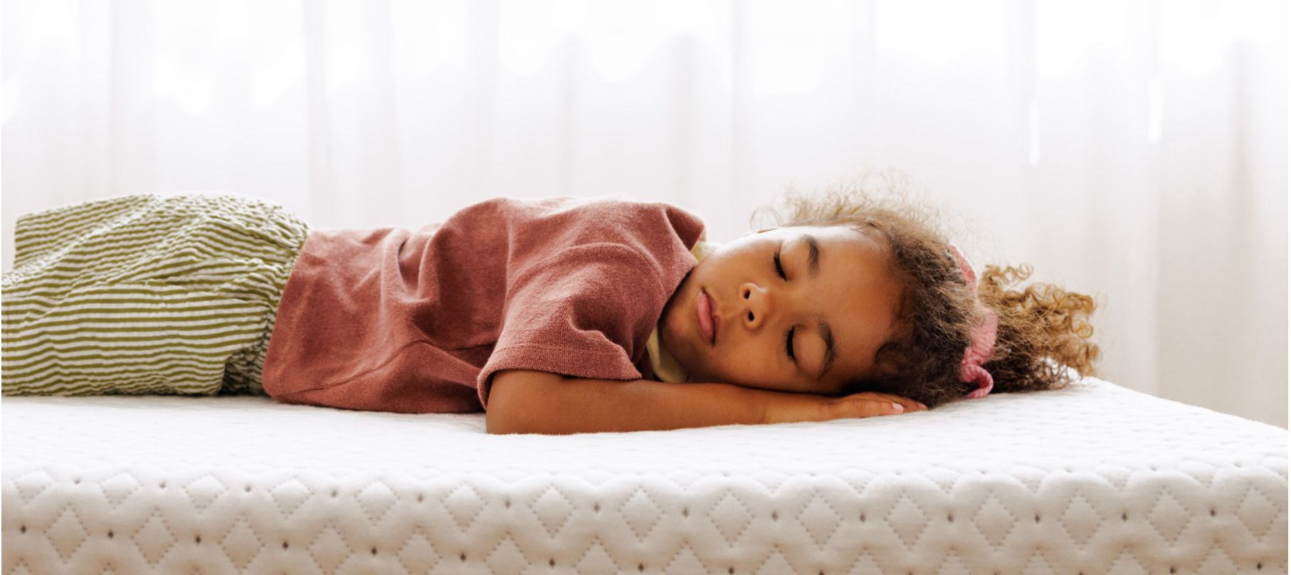 Little girl sleeping peacefully on a bare Endy mattress