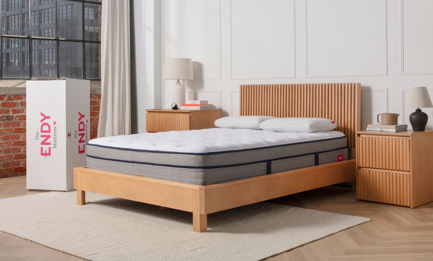 Bare Endy Hybrid mattress sitting on a wooden bed frame in a bedroom