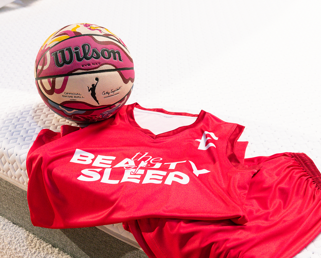Custom Endy x WNBA basketball on an Endy Mattress with an Endy "Beauty of Sleep" basketball uniform draped on it
