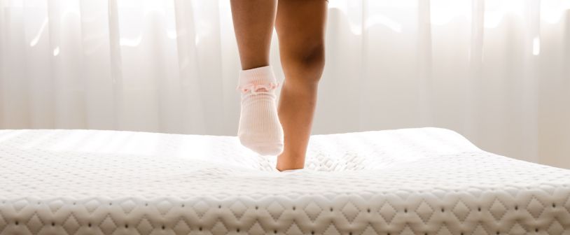 A kid jumping on the Endy Petit Mattress.