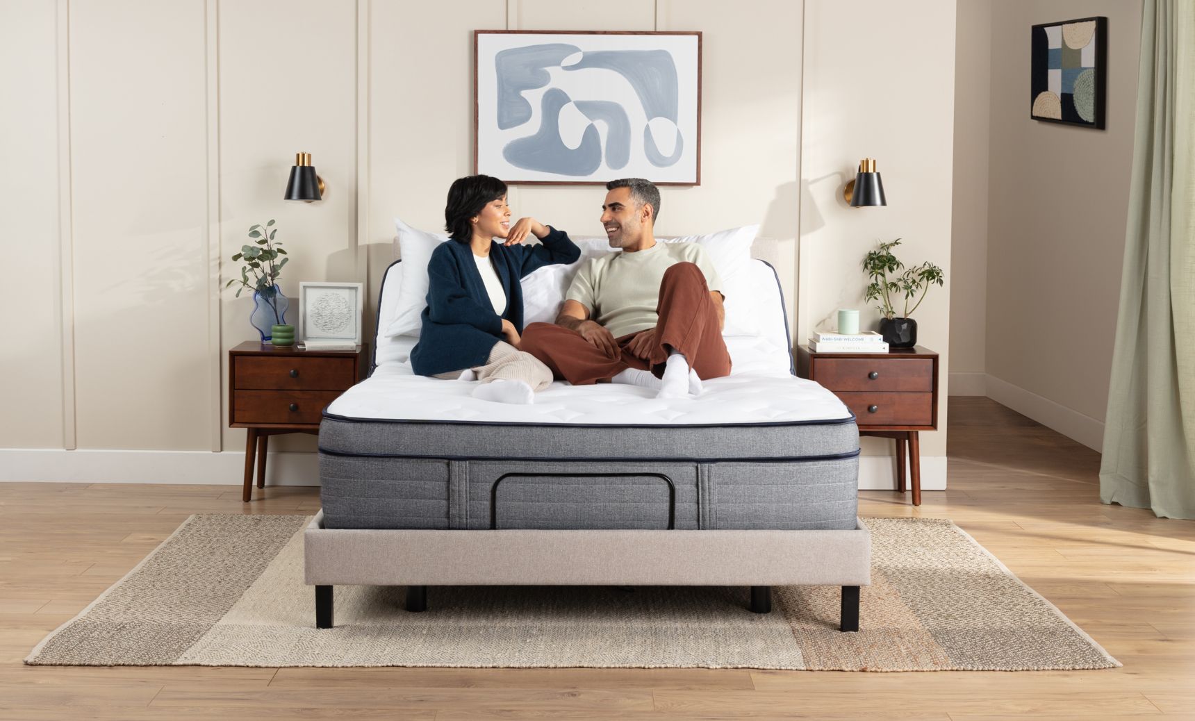 Woman and man sit on an inclined adjustable bed