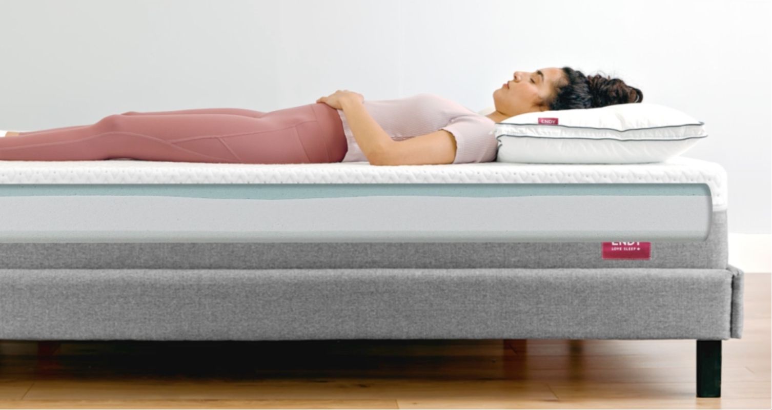 Image of woman sleeping on her back in bed
